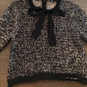 A black sweater with a touch of white & mauve